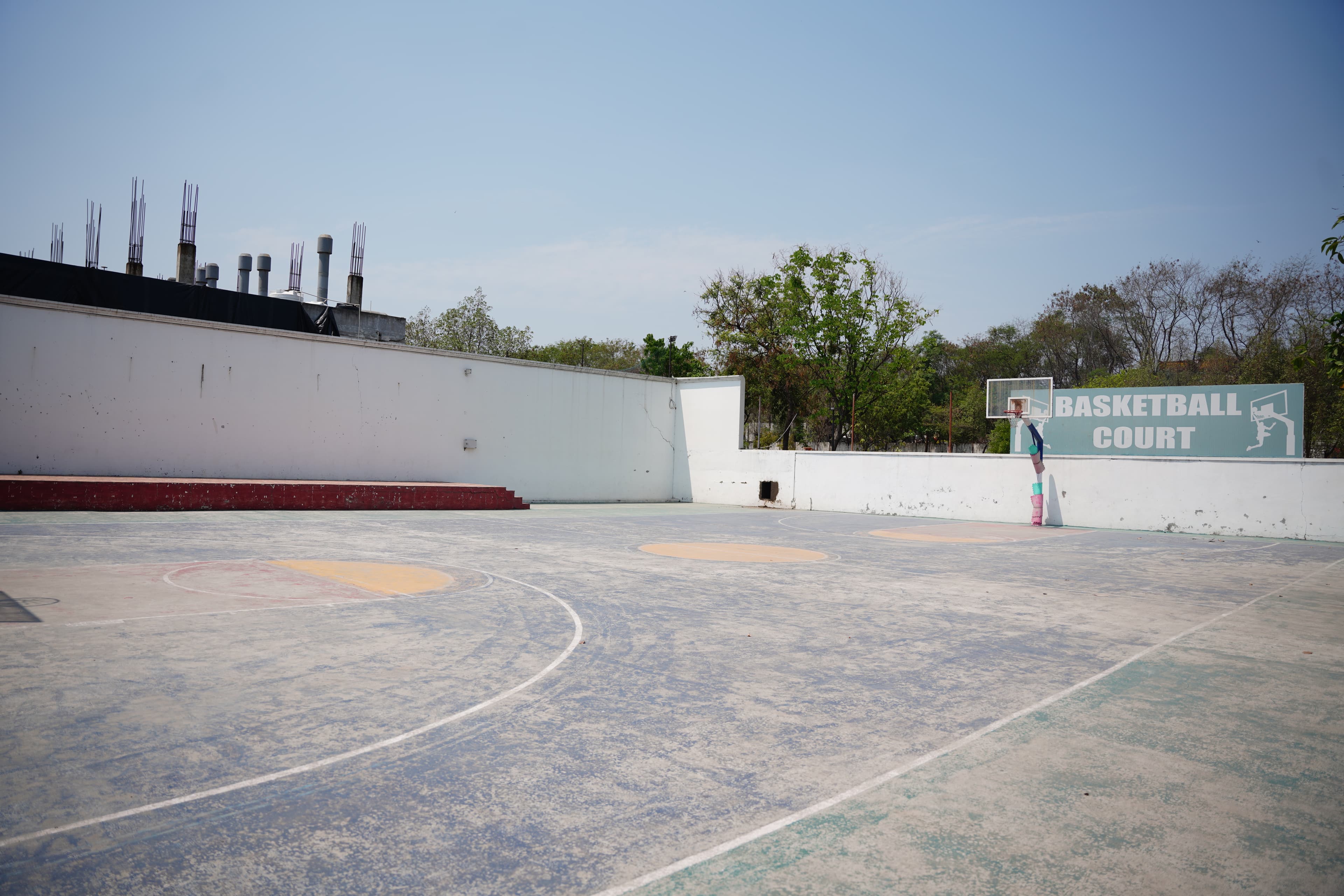 Outdoor basketball court and campus grounds at SMHS