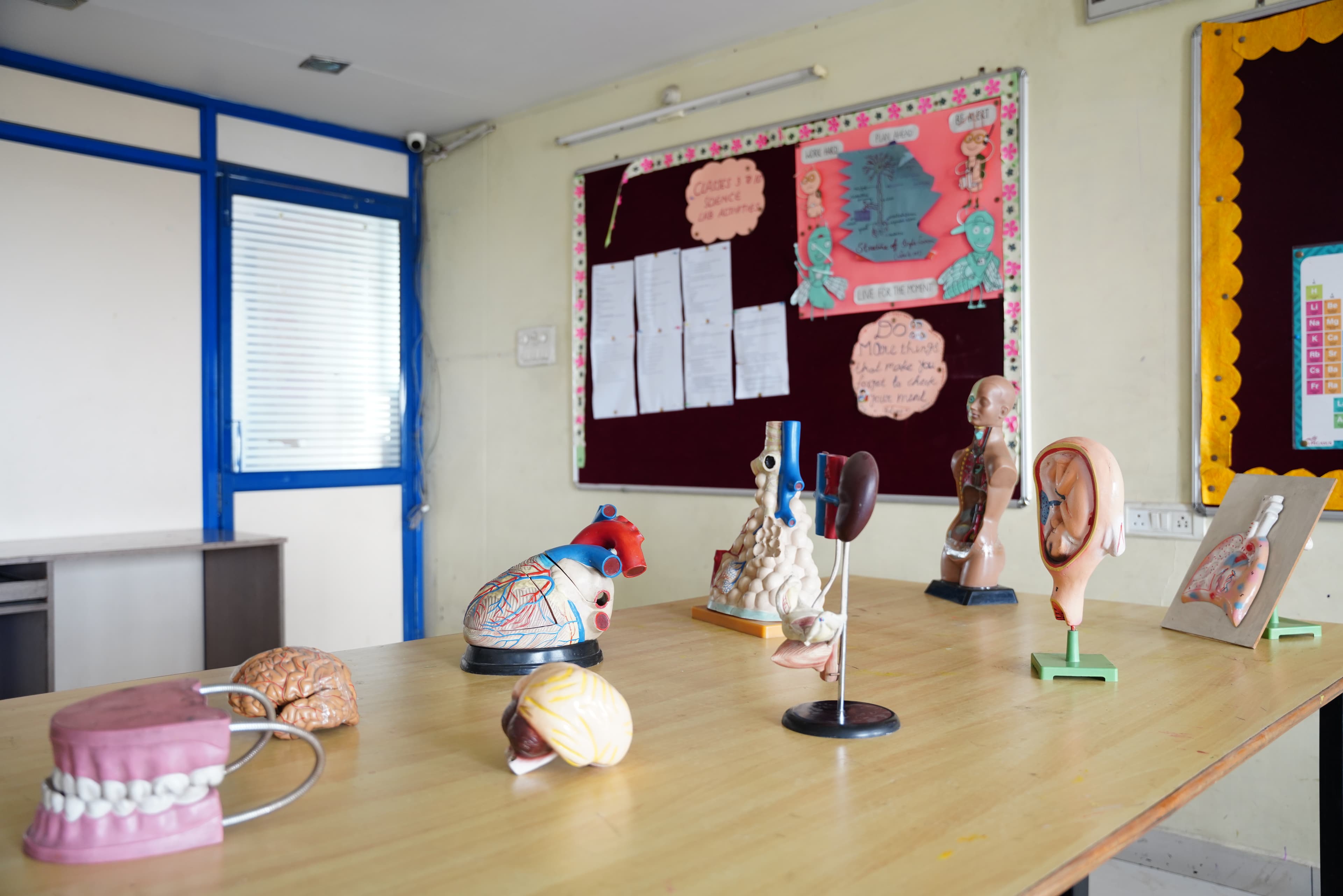 Art room with student paintings and craft desk