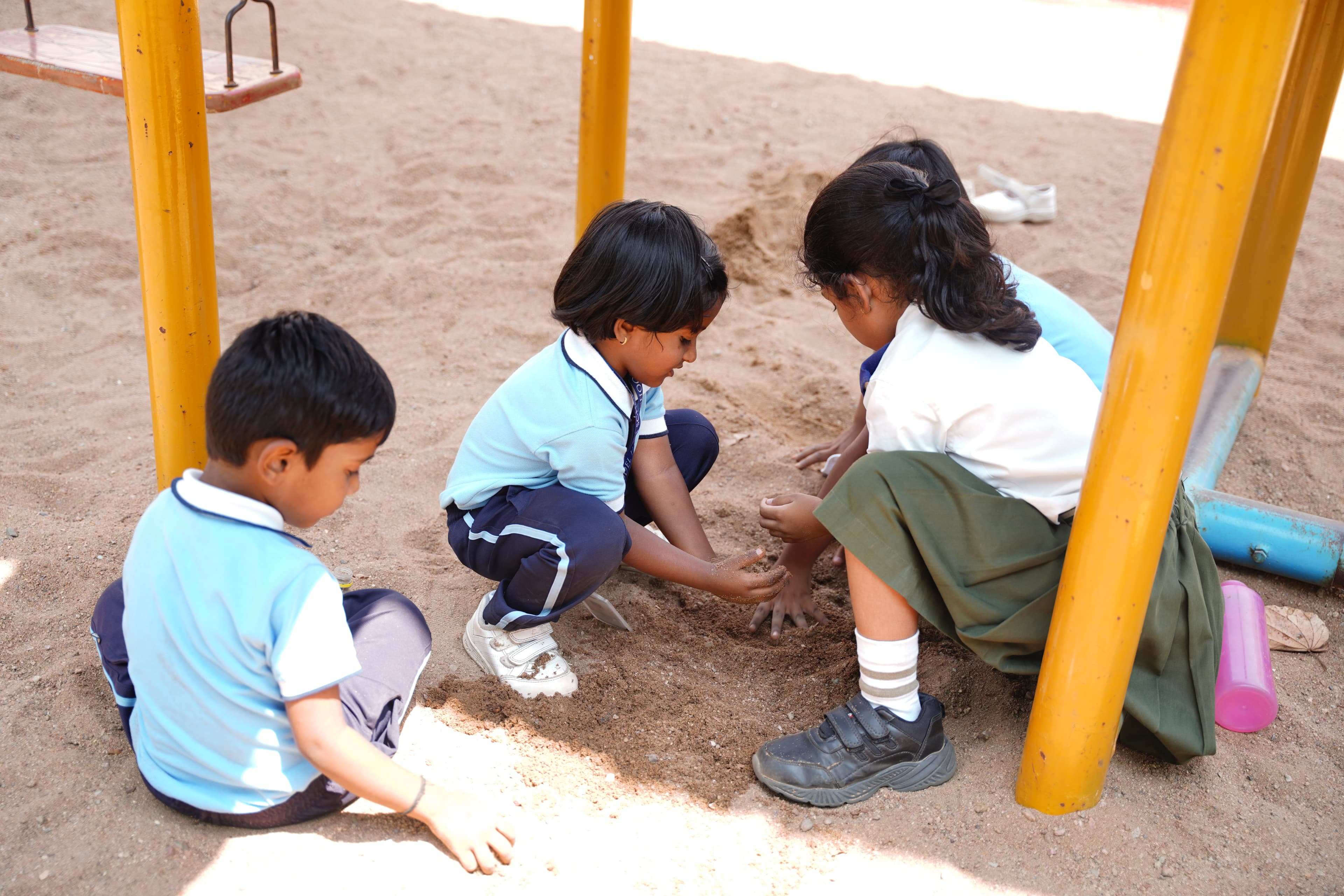 Pre-primary children playing in sand at Suprabhat Model High School