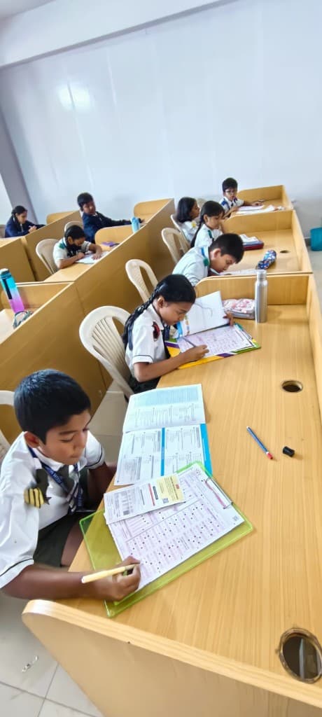 Students writing SOF Olympiad answer sheets in the exam hall